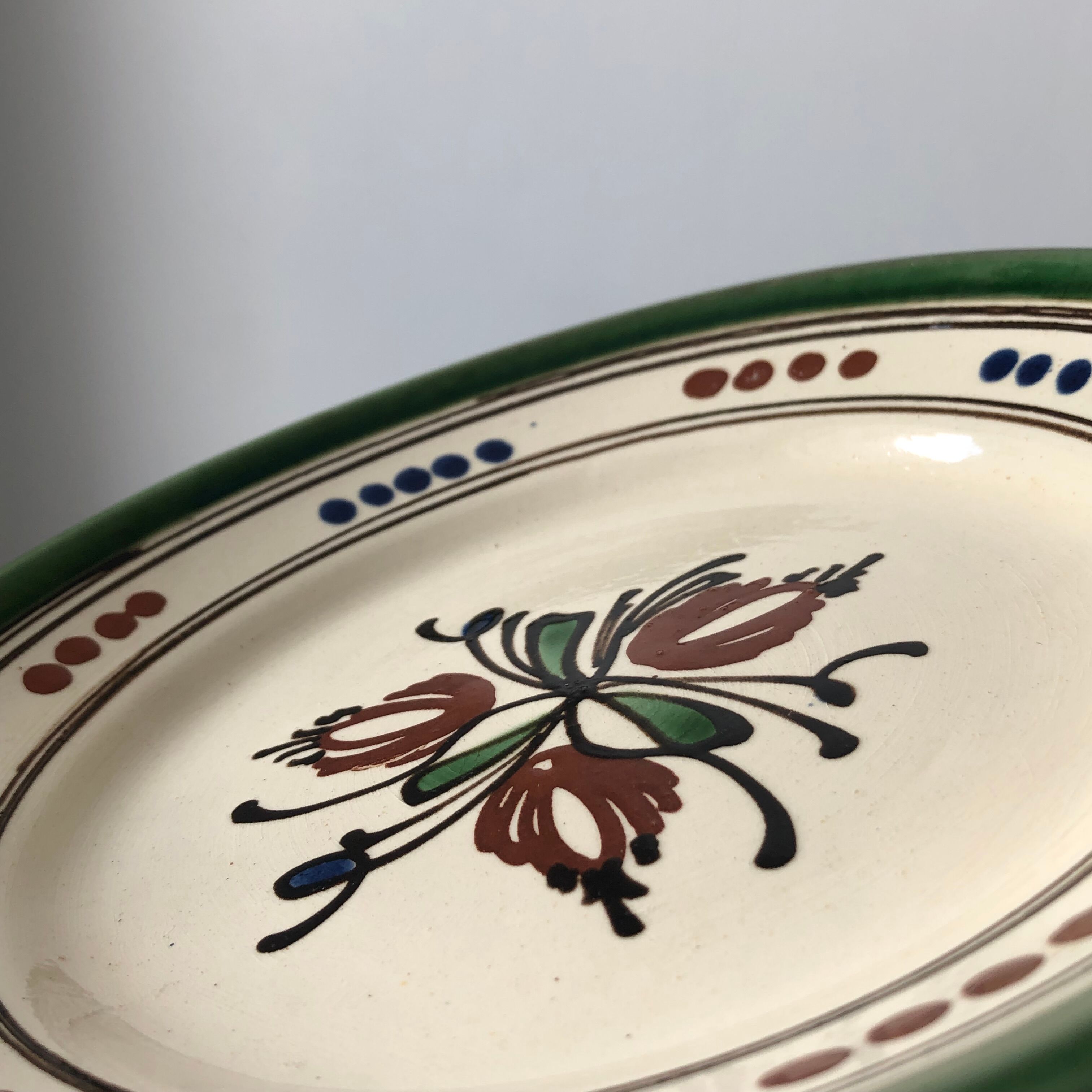Very decorative serving plate in terracotta, floral and geometric motifs.
