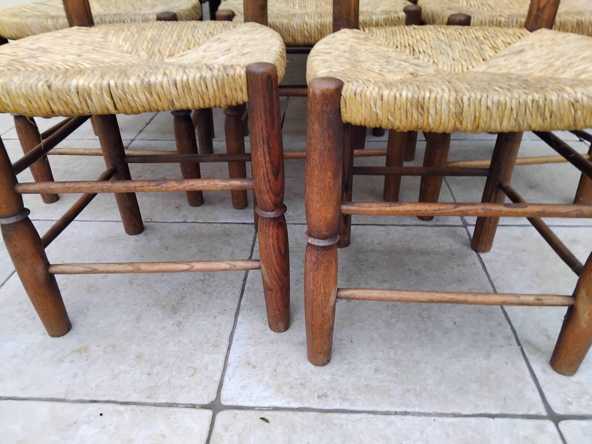 8 vintage straw chairs in the style of Charlotte Perriand.
