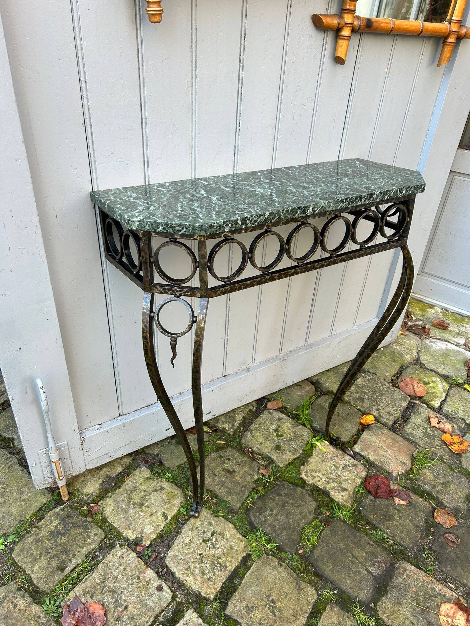 Console in wrought and hammered iron and green marble