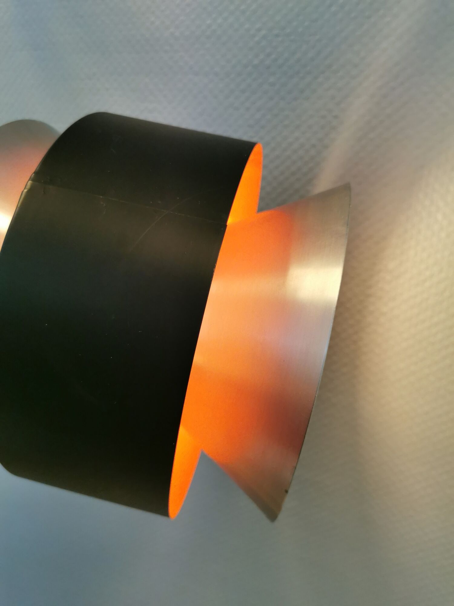 Hanging lamp,  of silver coloured aluminium with black "ring" and orange inner contrast lacquer.