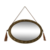 Golden oval mirror with its wooden frame and stucco on wood, nicely cracked by time