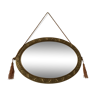 Golden oval mirror with its wooden frame and stucco on wood, nicely cracked by time