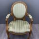 Pair of Louis XVI style armchairs in striped green fabric, 20th century.
