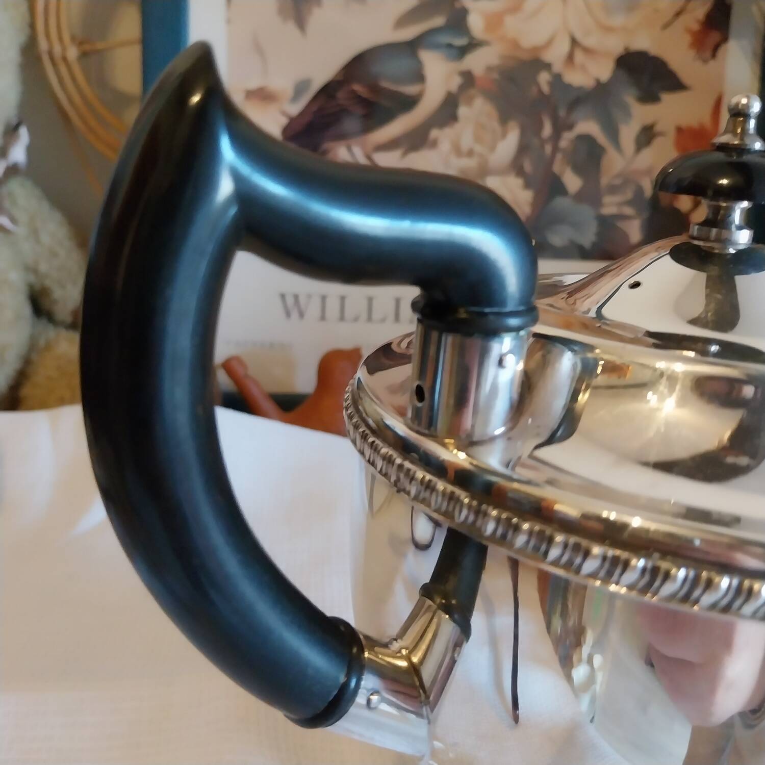 Old English teapot in silver-plated metal and Bakelite.