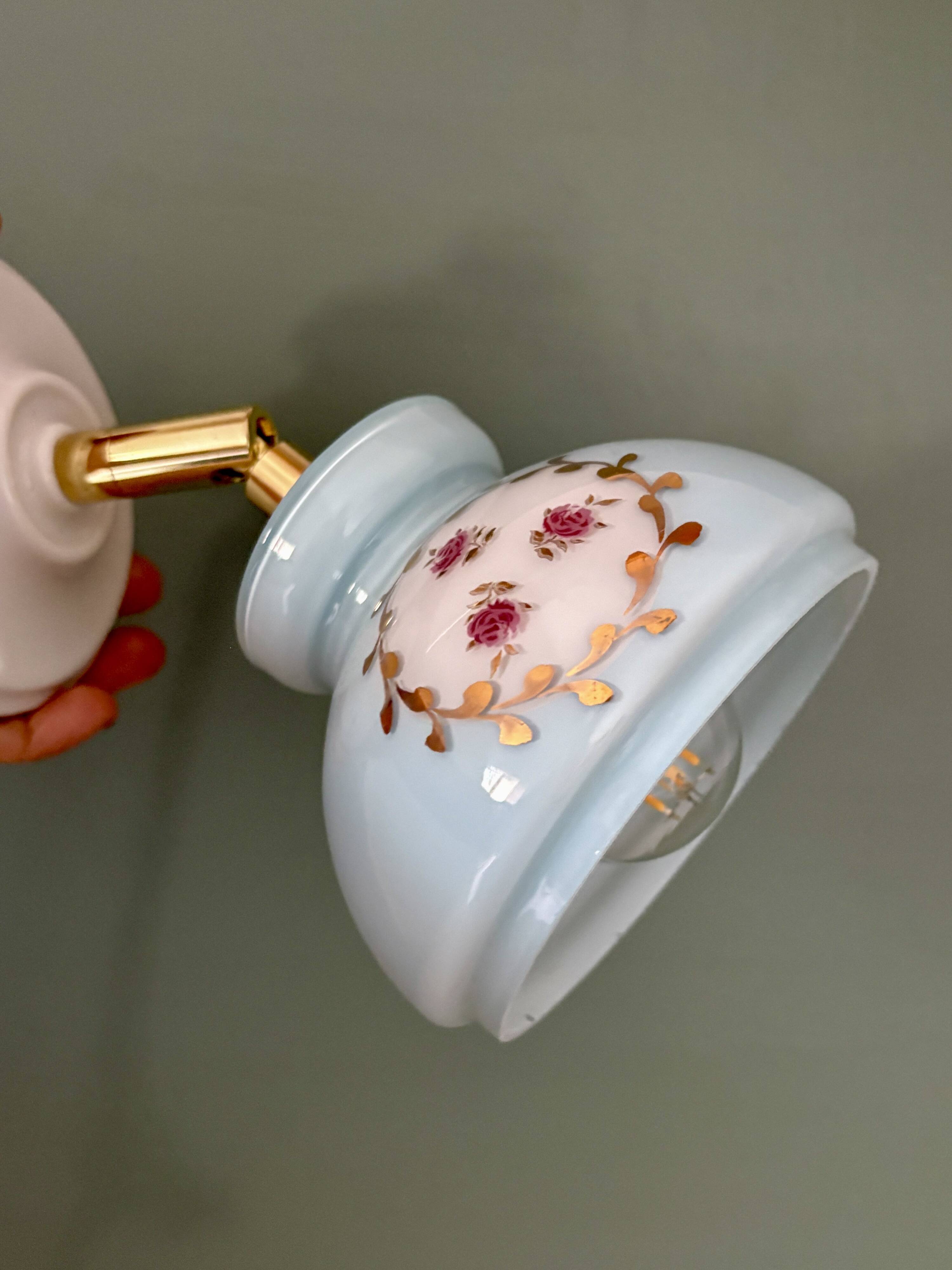 Vintage wall sconce with blue opaline glass shade and floral decorations
