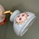 Vintage wall sconce with blue opaline glass shade and floral decorations