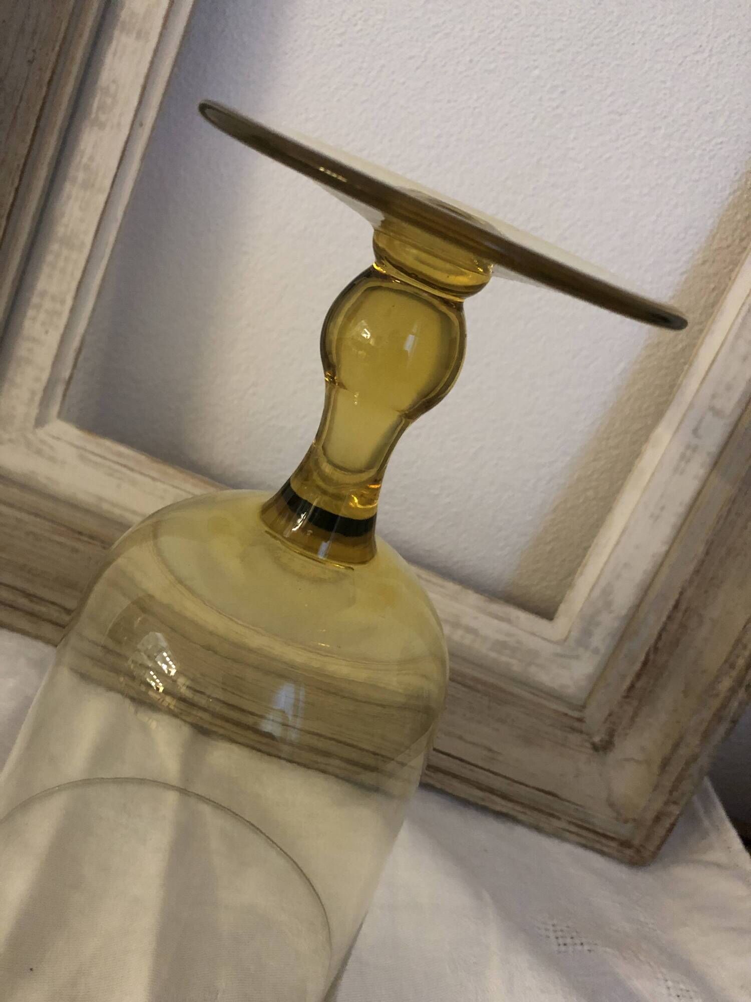 Yellow chalice vase, yellow glass vase on a pedestal.