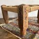 Low stool with carved wood and braided cord.