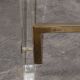 1970s dining table in travertine, gold metal and plexiglass.