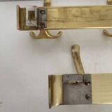 Three vintage 1960s gold coat racks 4, 3 and 2 hooks