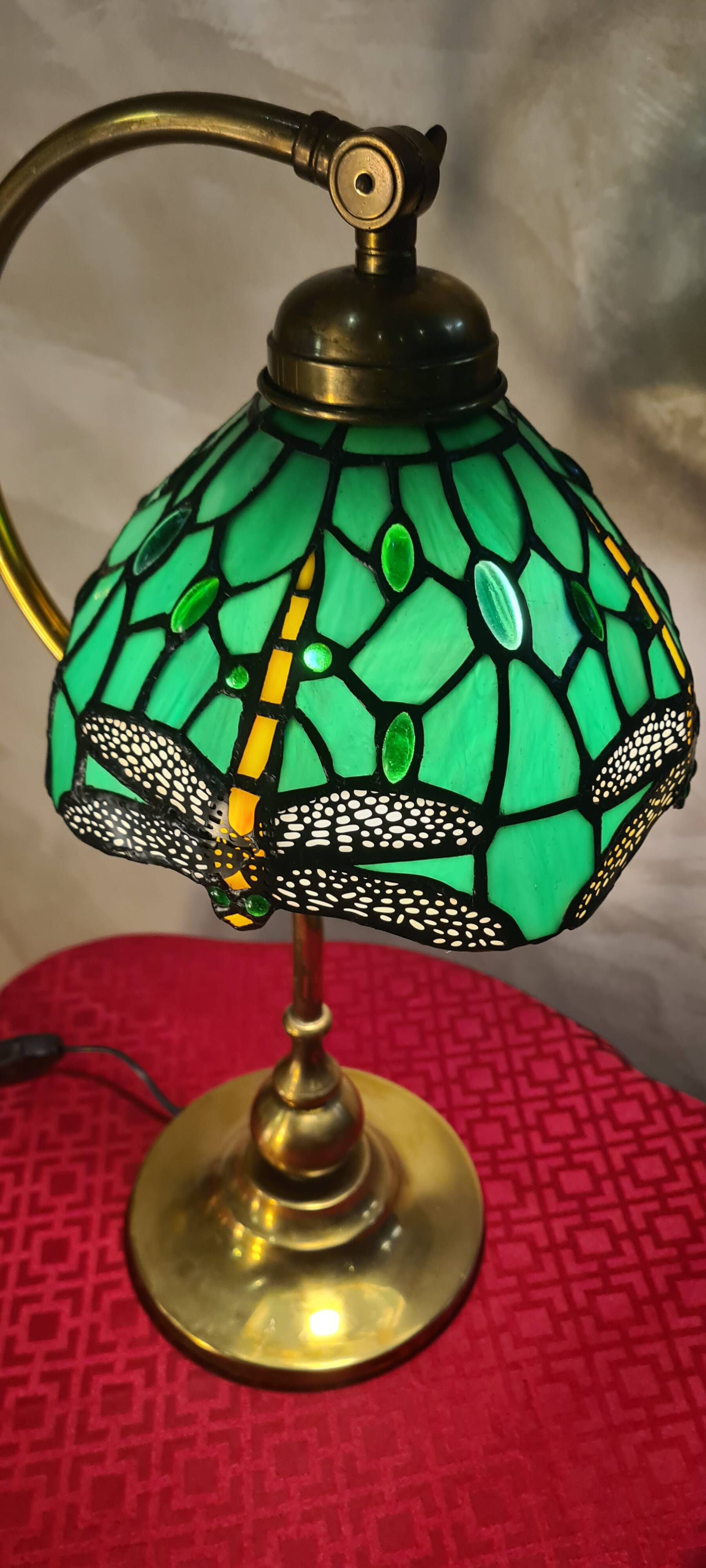 brass lamp with green stained glass shade.