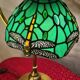 brass lamp with green stained glass shade.
