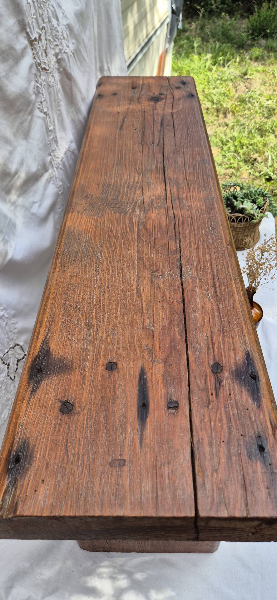 Brutalist wooden bench made of solid oak beam.