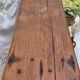 Brutalist wooden bench made of solid oak beam.