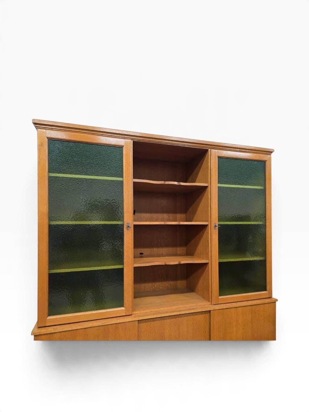 Vintage wooden display cabinet with green glass.