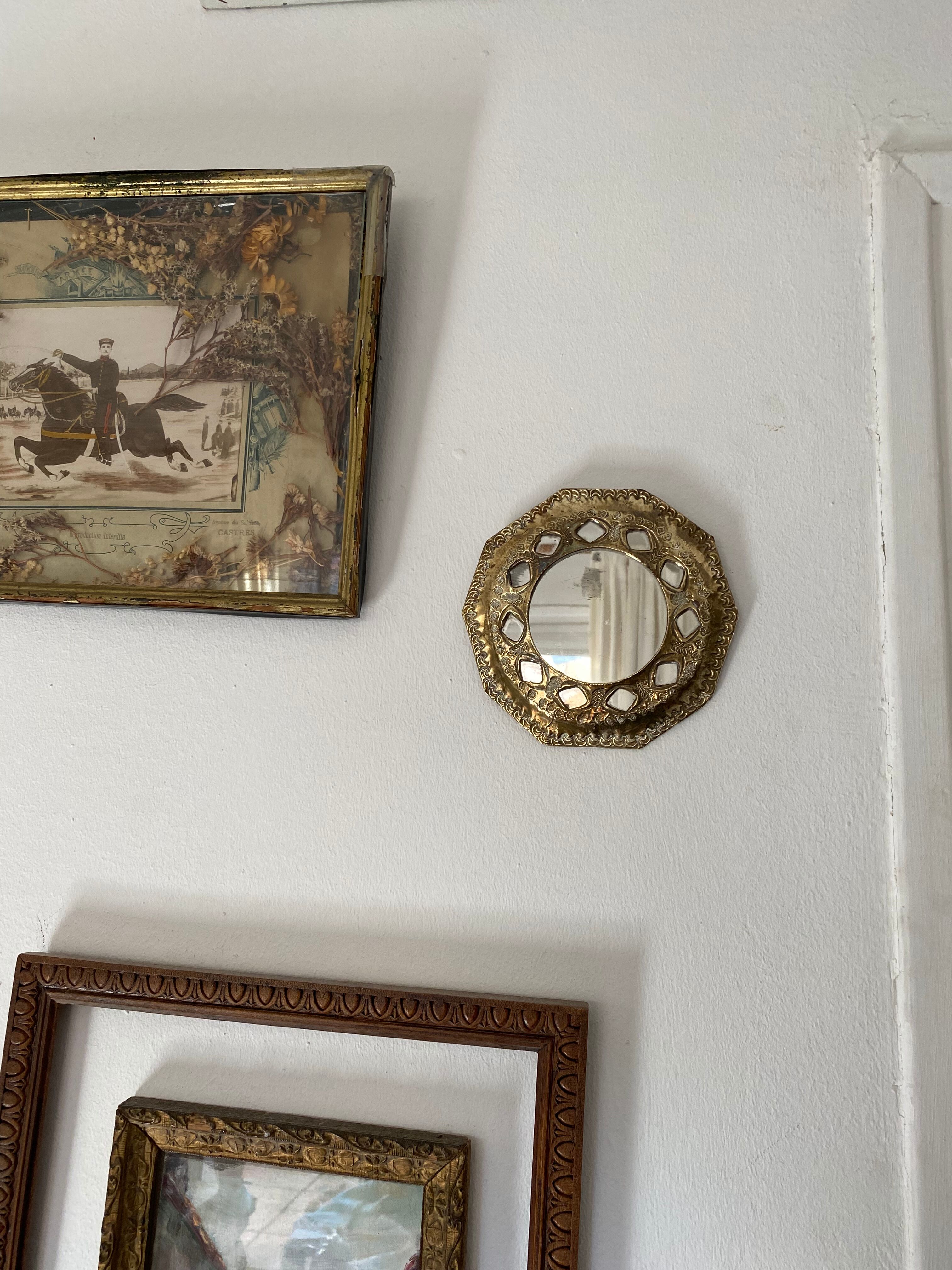 Antique mirror in worked brass
