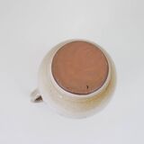Glazed ceramic jug with plant decoration