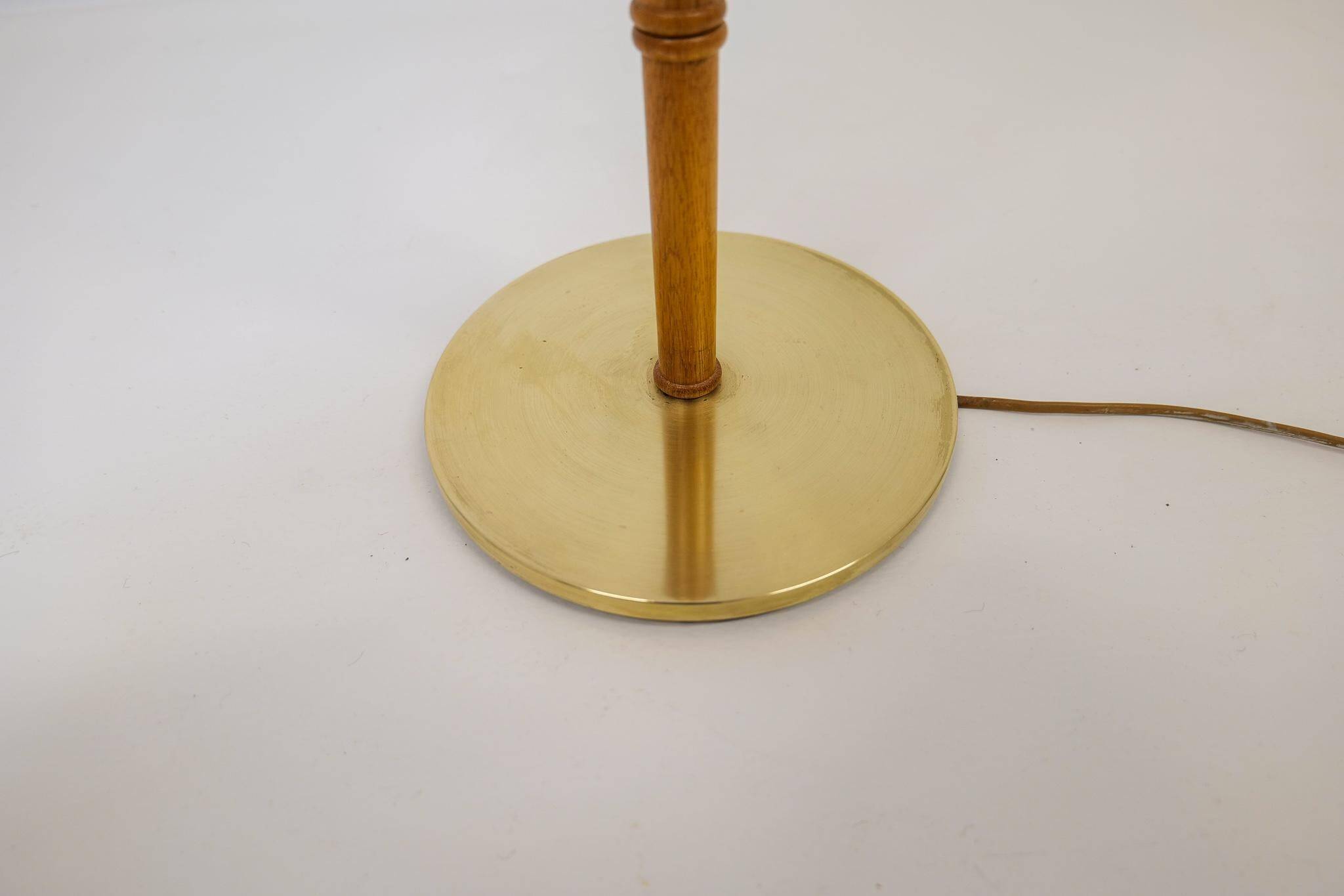 Mid-century floor lamp in brass and oak by Falkenbergs Belysning, Sweden, 1960s.