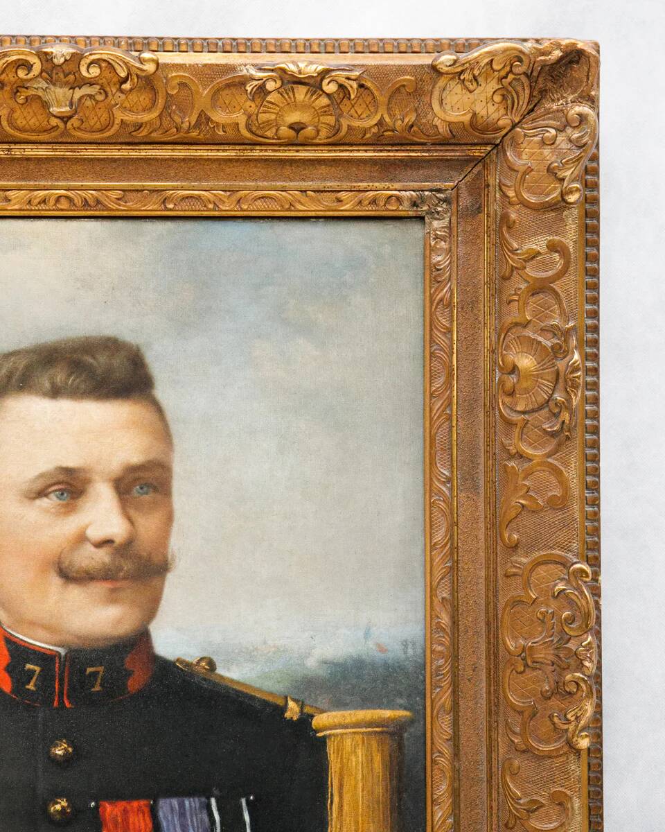 Antique portrait painting of a decorated gentleman with icy blue eyes