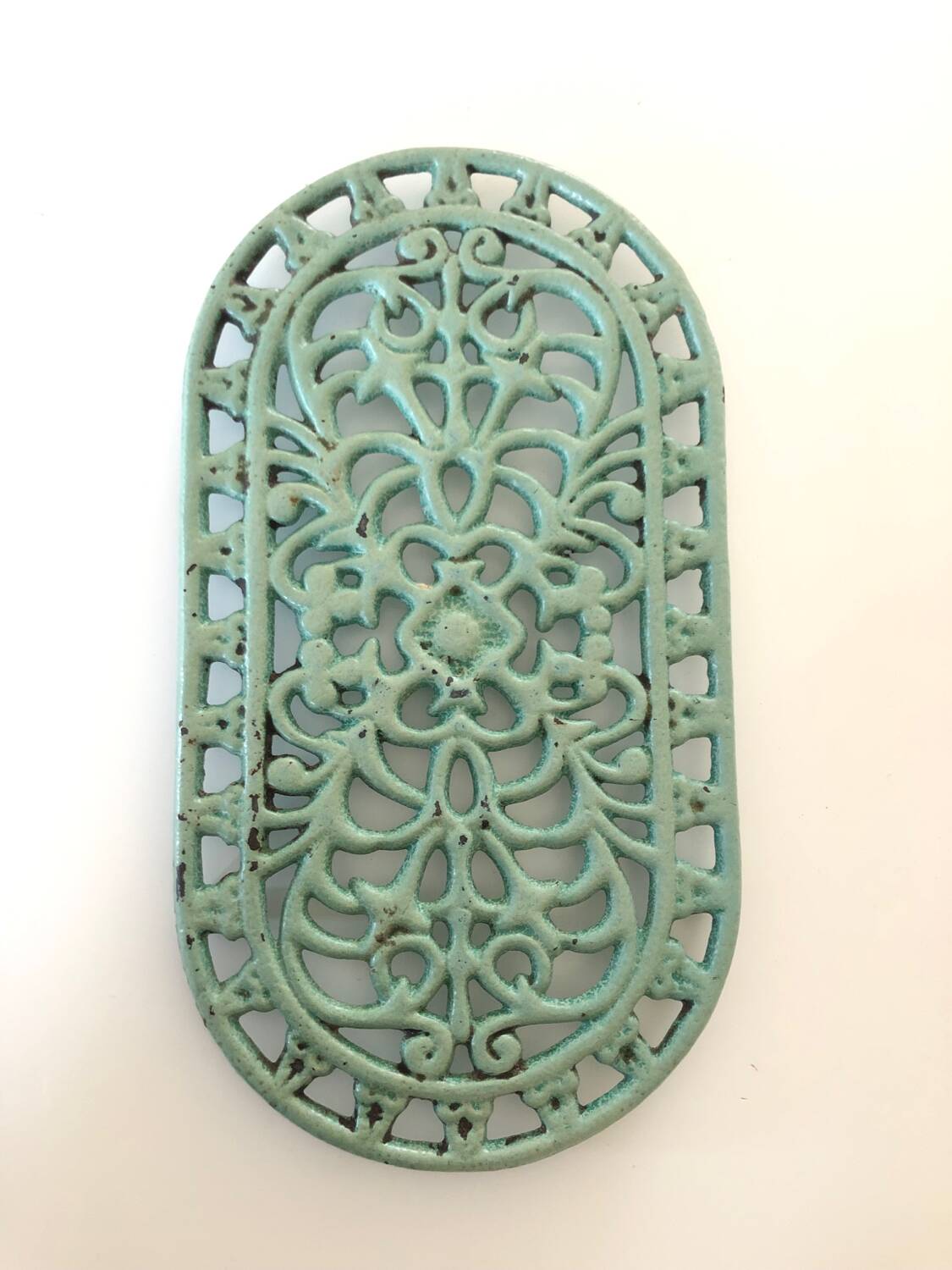 Oval trivet in green enameled cast iron