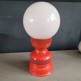 Vintage globe lamp with a metal base, perforated and lacquered in red.