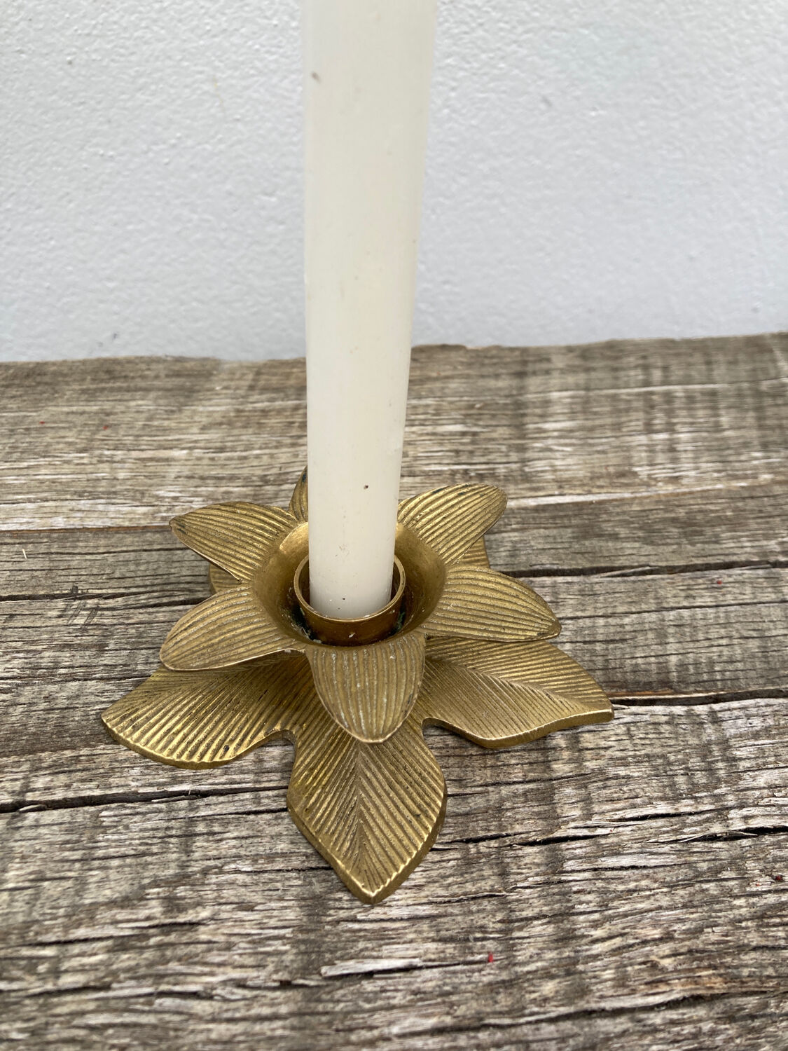 Old golden brass candle holder in the shape of a leaf or flower