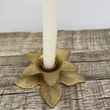 Old golden brass candle holder in the shape of a leaf or flower