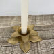 Old golden brass candle holder in the shape of a leaf or flower