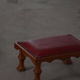 Danish sculpted oak stool from the mid-20th century with a red leather seat, 1950s.