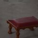 Danish sculpted oak stool from the mid-20th century with a red leather seat, 1950s.
