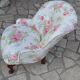 1950s vintage armchair in white and pink floral fabric, mahogany wooden legs.