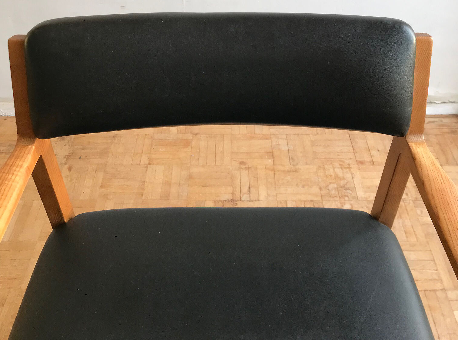 Chair in light teak and black skaï from the 1960s