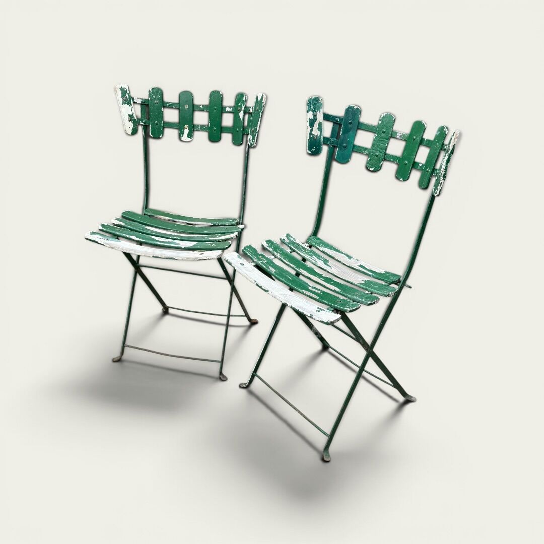 Pair of original patinated folding Parisian bistro chairs.