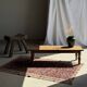 Brown Indonesian teak coffee table, with a border and cylindrical legs H40 L103.
