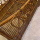 Vintage rattan baby cot on wheels.