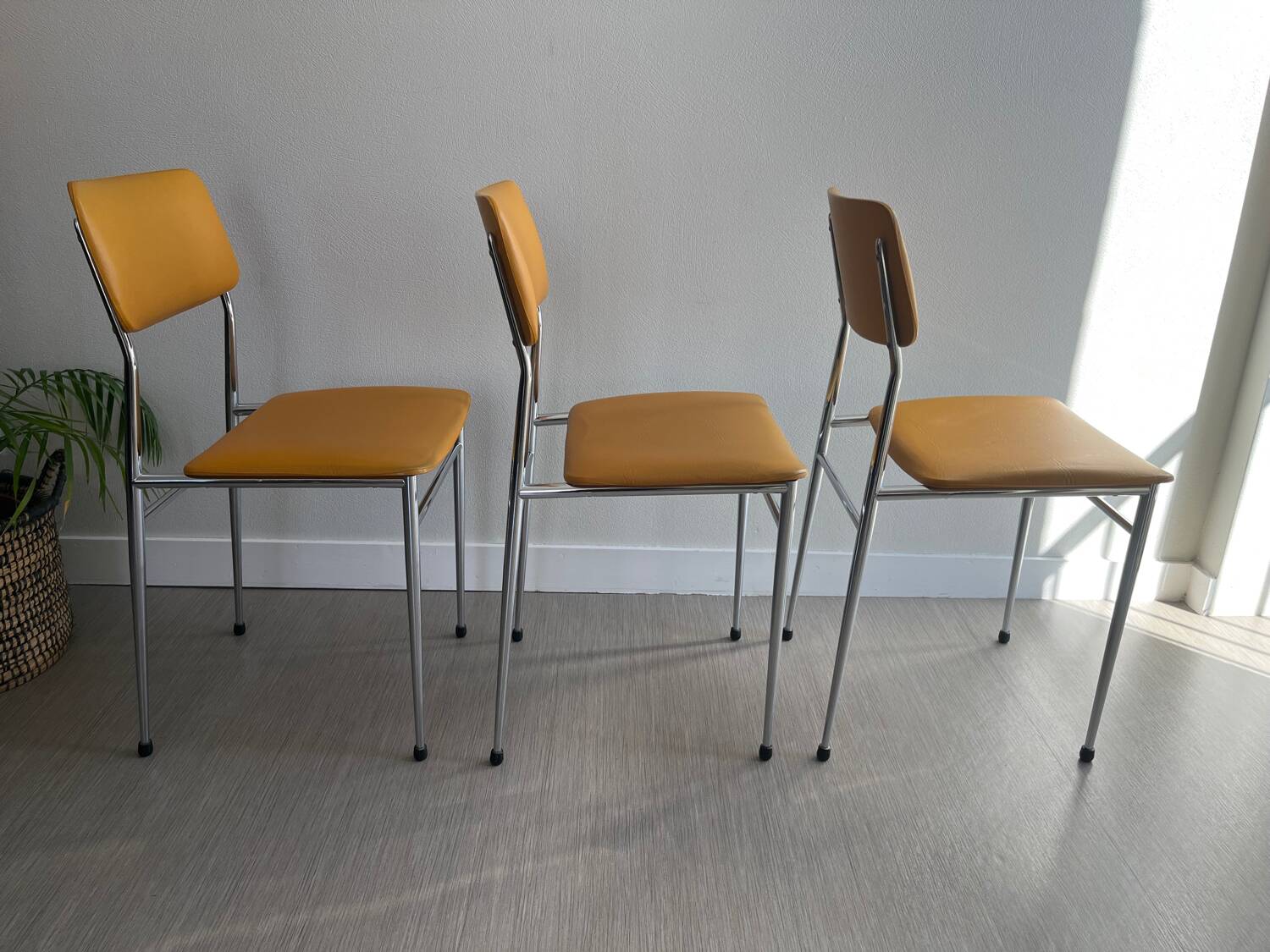 LM vintage chrome and orange/mustard yellow faux leather chairs