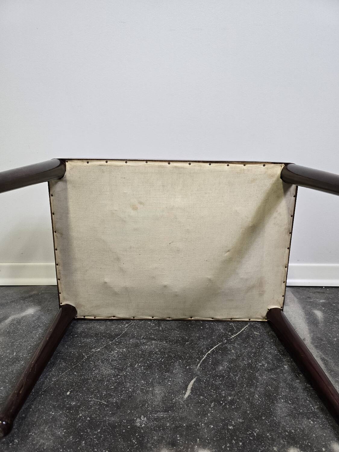 Vintage wooden ottoman from the 1940s with a silk top and studded trim.