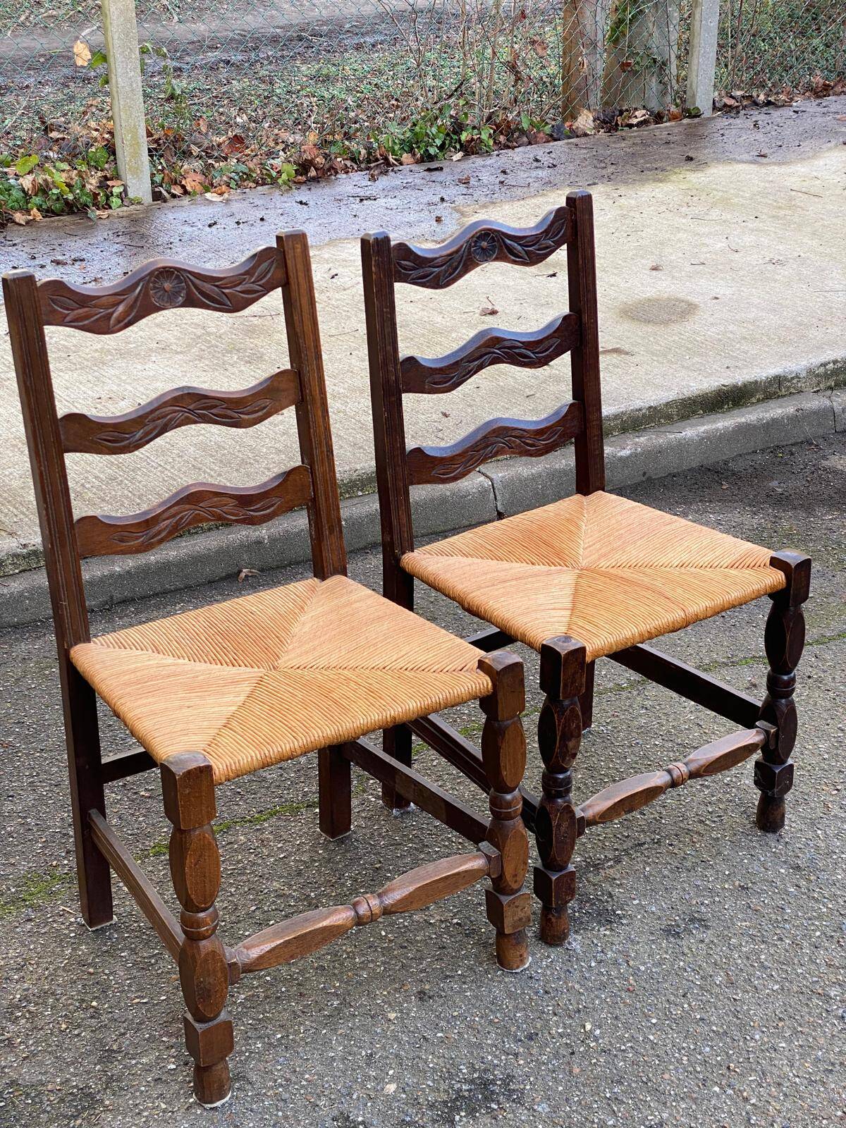 2 solid wood chairs with carved rush seats