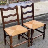 2 solid wood chairs with carved rush seats