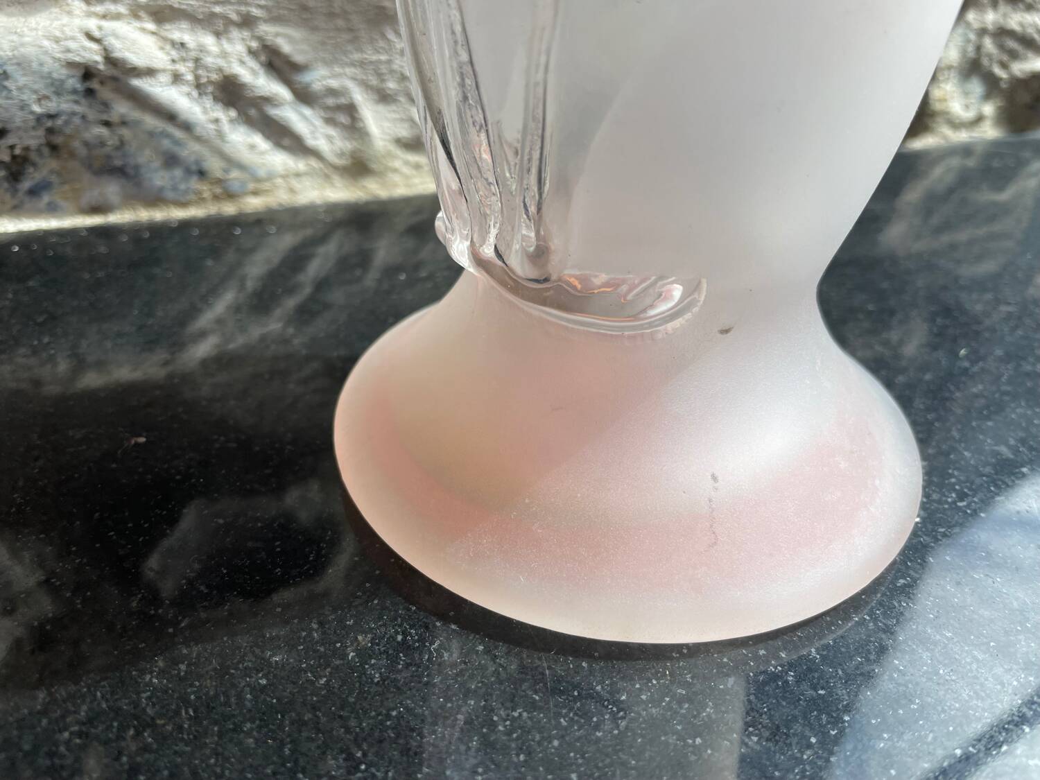 Pink glass vase decorated with tulips