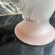 Pink glass vase decorated with tulips