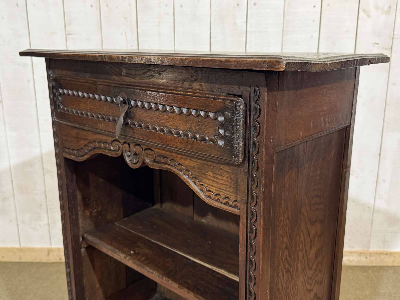 Oak accent furniture bookshelf with a drawer, early 20th century work.