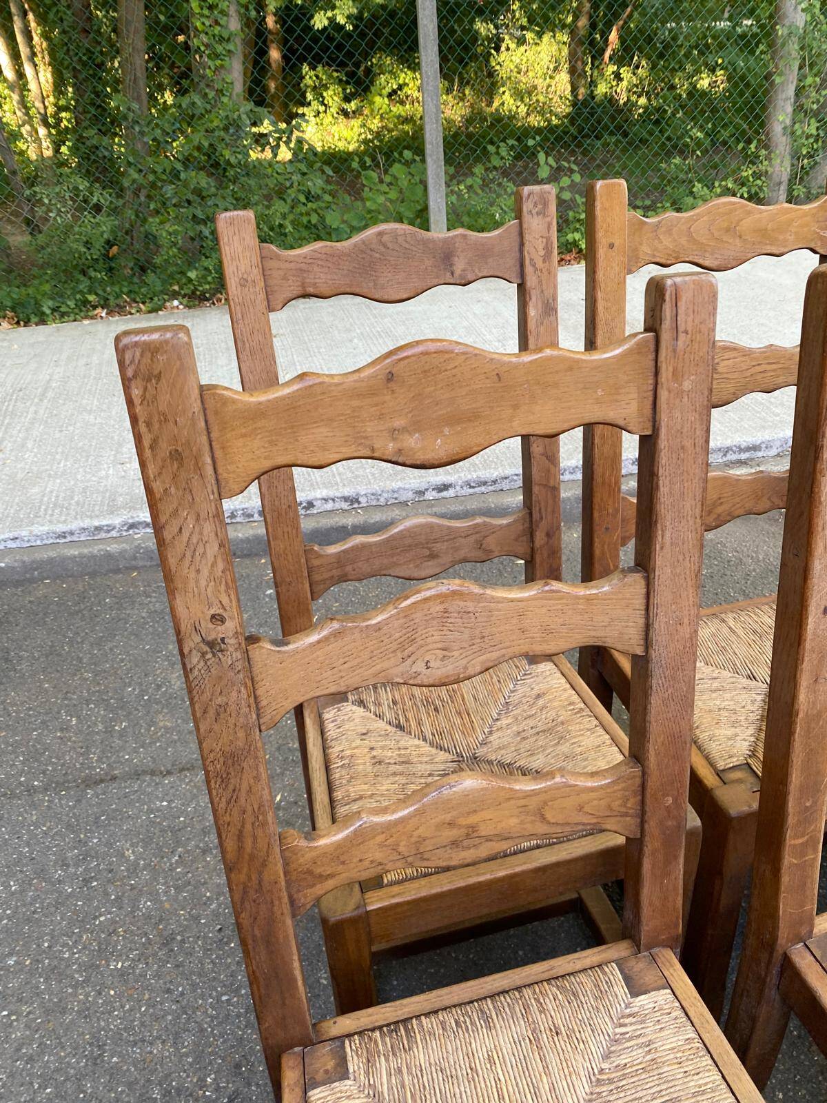 6 solid oak chairs with rush seats in a country style.