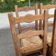 6 solid oak chairs with rush seats in a country style.