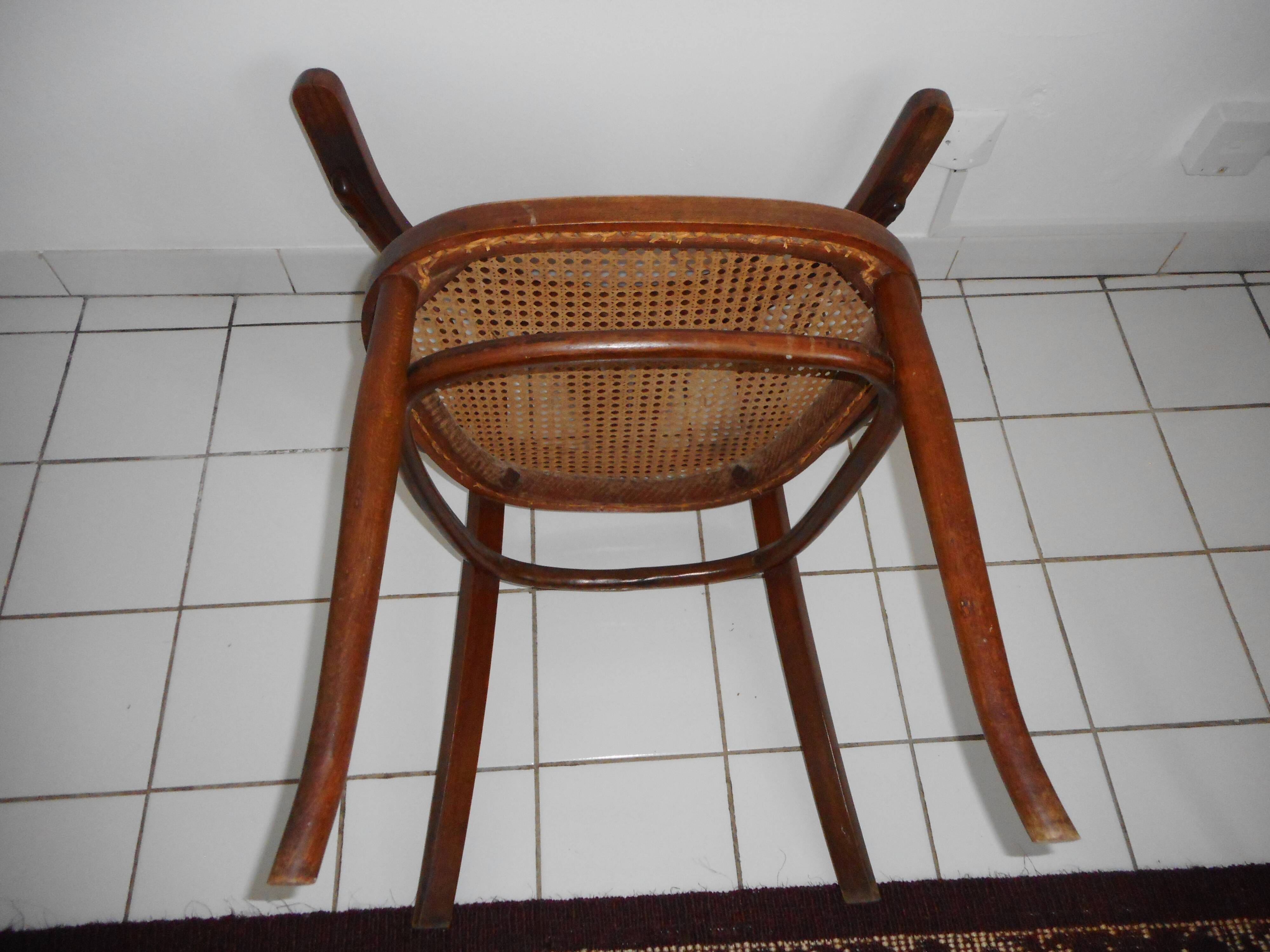 Wooden armchair with caned base