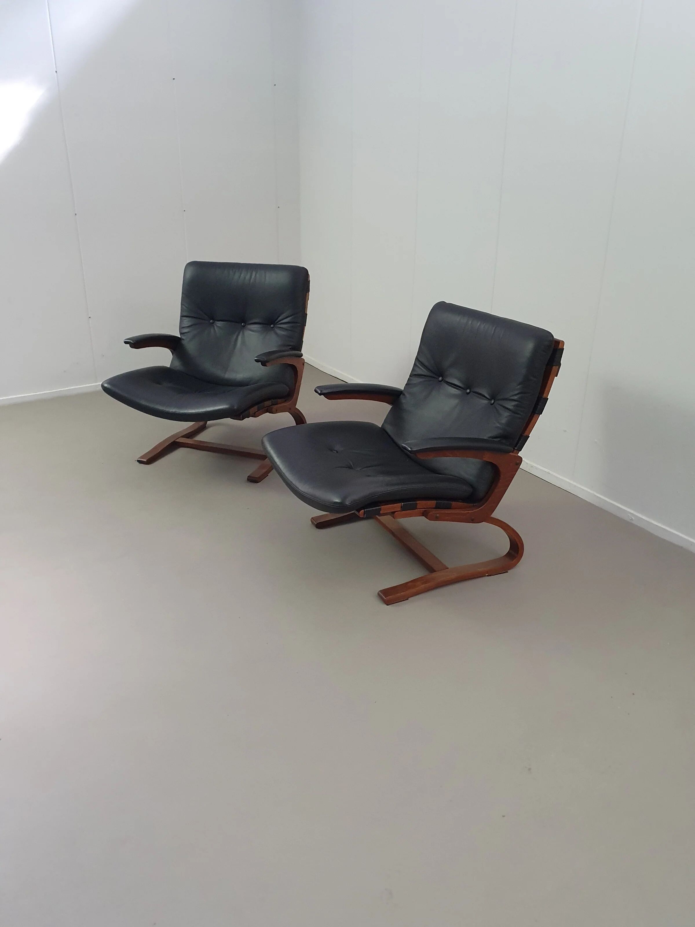 2 x Scandinavian black leather lounge chairs