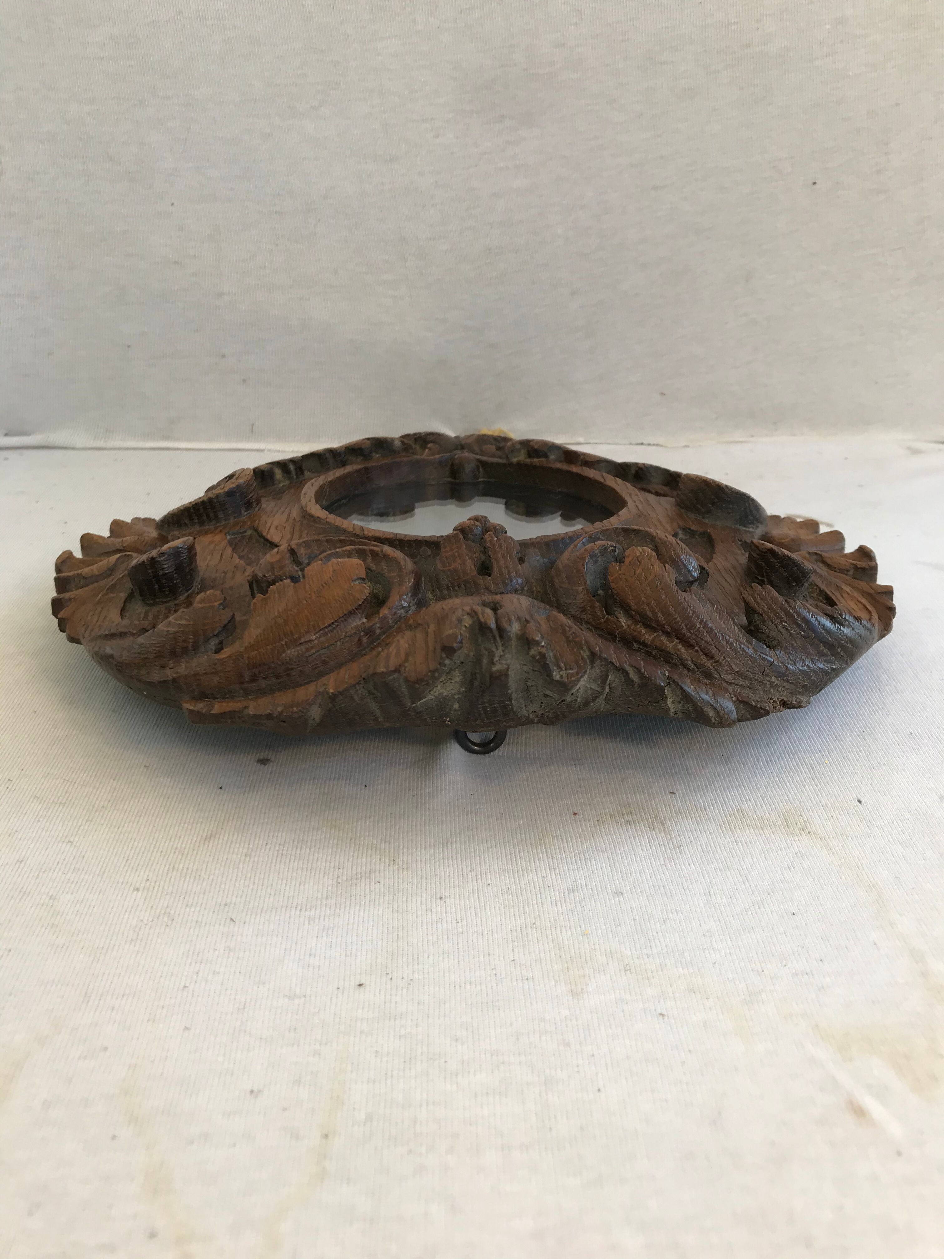 Ancient mirror in carved wood, vintage decoration