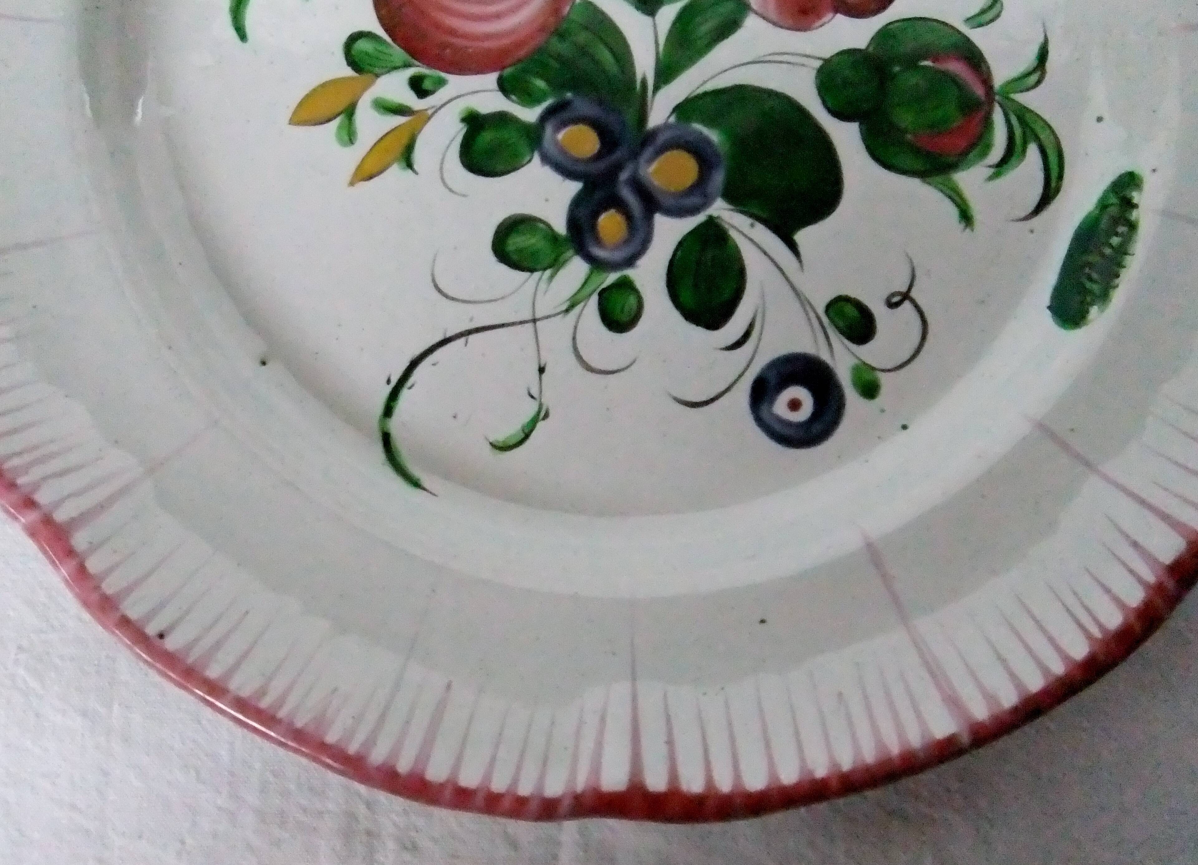 Old earthenware plate of the East Strasbourg decorated with flowers