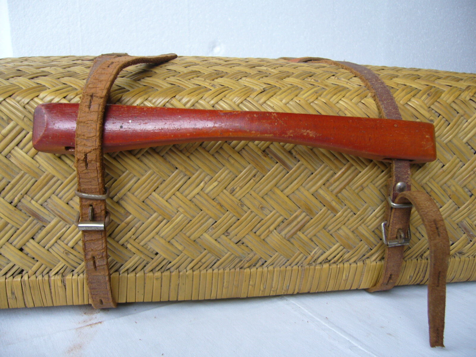 Old rattan case with leather straps and wooden handle