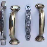 Seven art deco silver tone and brass handles